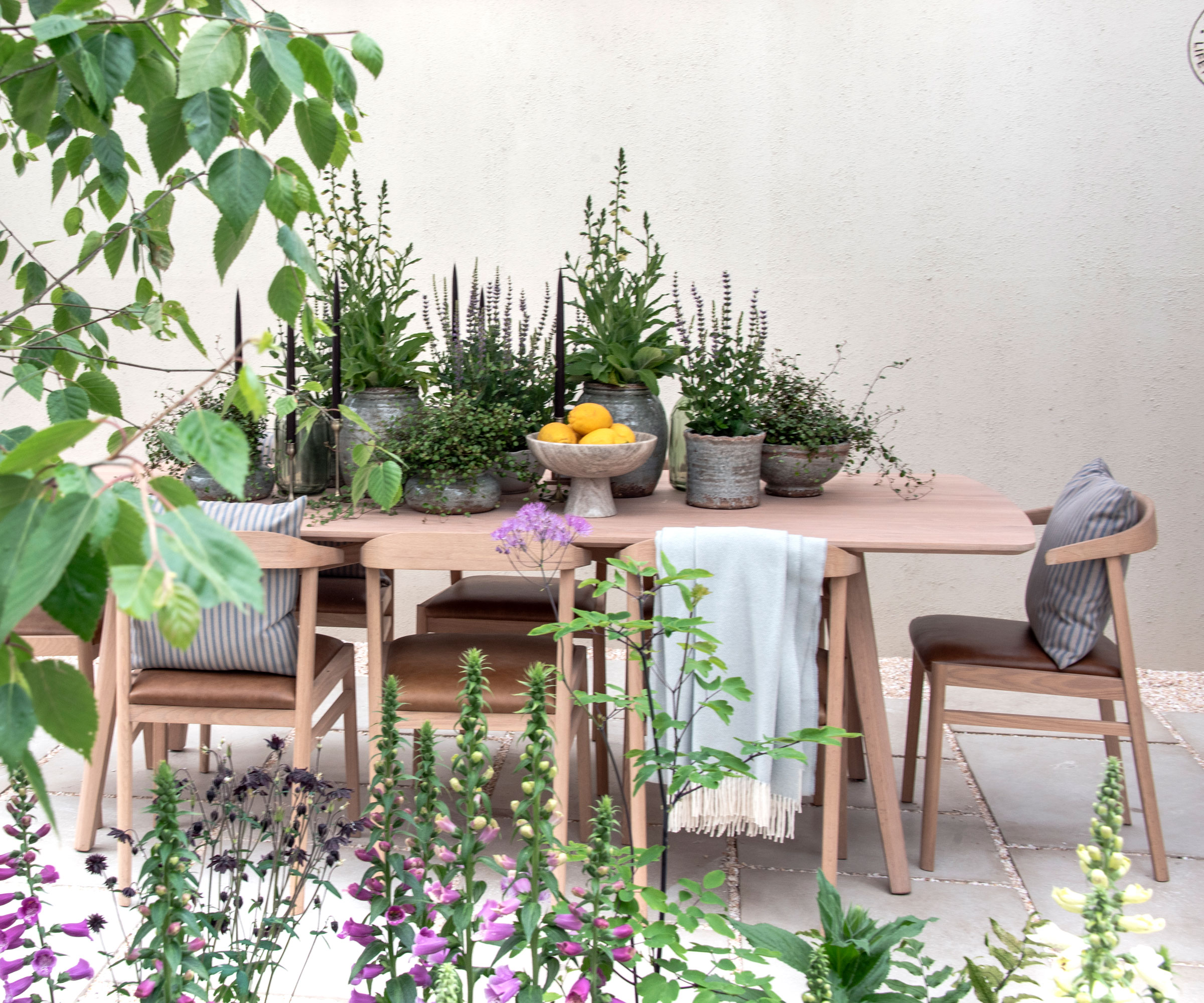 outdoor dining set with table, chairs, cushions, throws and other accessories