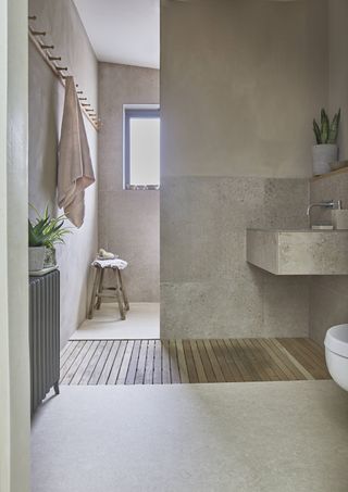 neutral bathroom with vinyl flooring, pared back style, wet room in background