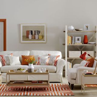 living room with white sofa set with printed cushions