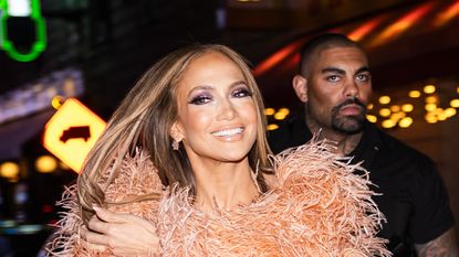 Jennifer Lopez wearing a peach red carpet outfit