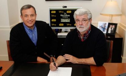 Walt Disney chairman and CEO Bob Iger (left) and Lucasfilm founder George Lucas sign the agreement that hands over Star Wars and the rest of Lucas' company over to Disney.