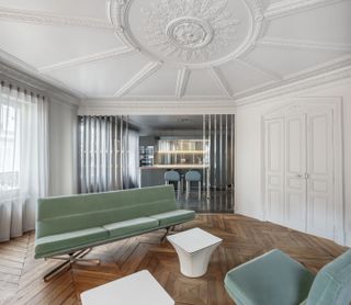 contemporary living room with green sofa and detailed ceiling medallion