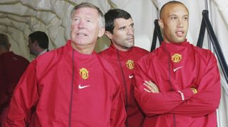 Sir Alex Ferguson, Roy Keane and Mikael Silvestre of Manchester United shelter from the rain during a first team training session in the Stefan cel Mare stadium in Bucharest ahead of their UEFA Champions League qualifying match against Dinamo Bucharest on August 10, 2004 in Bucharest, Romania.