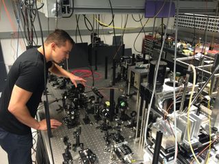 University of Chicago's Paul Klimov adjusts the intensity of a laser beam during an experiment to entangle atoms at room temperature.