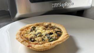 air fryer coronation quiche on a plate next to air fryer