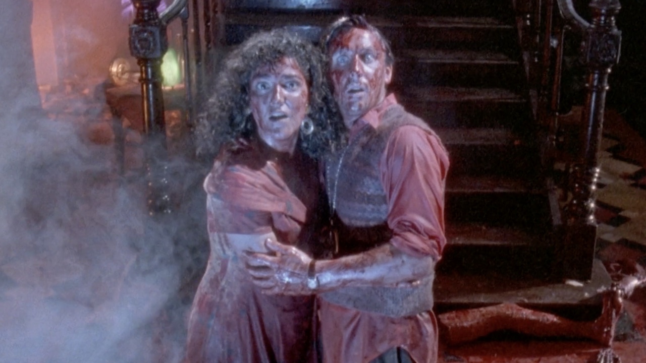 Two people look bloody and scared in Dead Alive (aka Braindead)