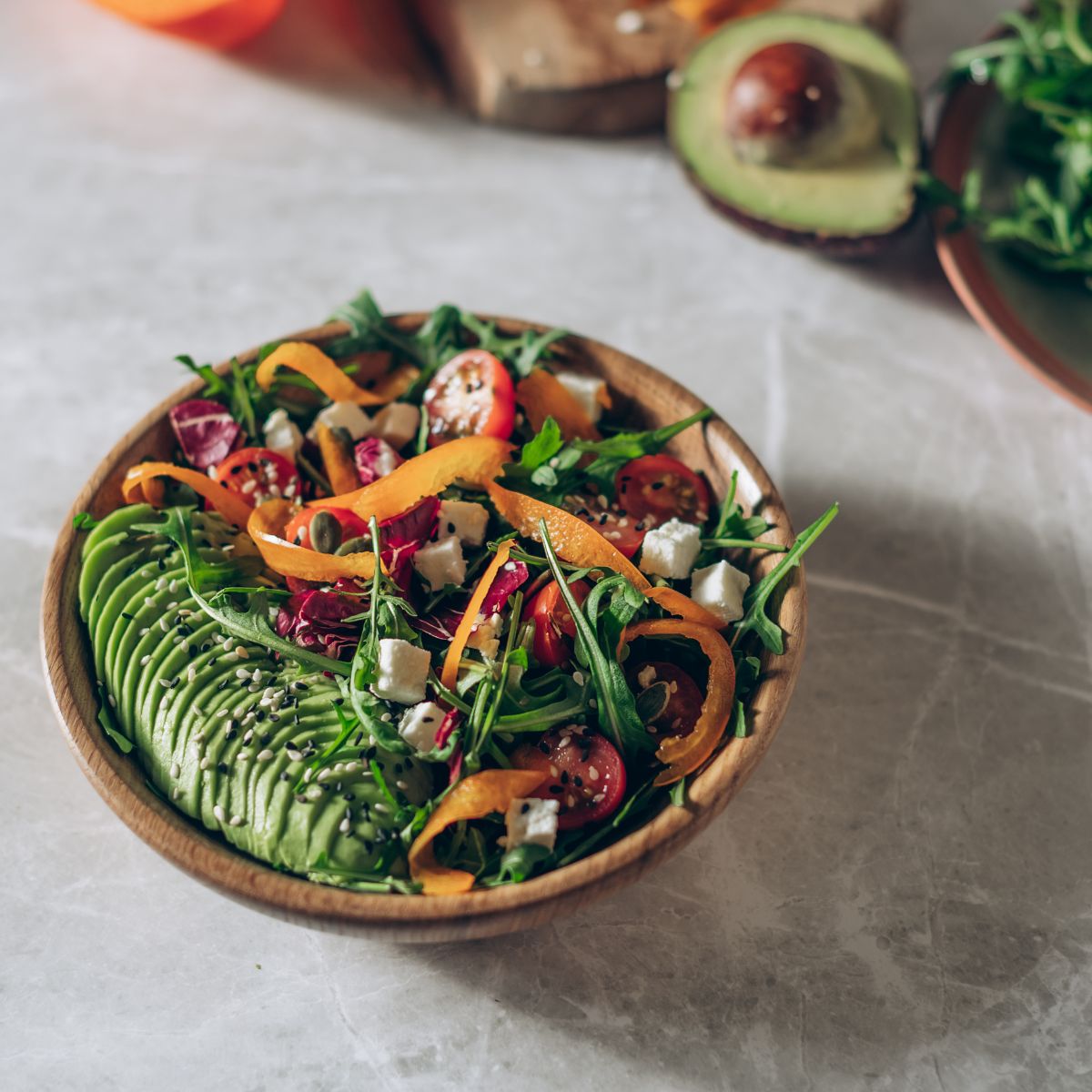 Glucose guarding: A bowl of salad with avocado, carrot, rocket and radish