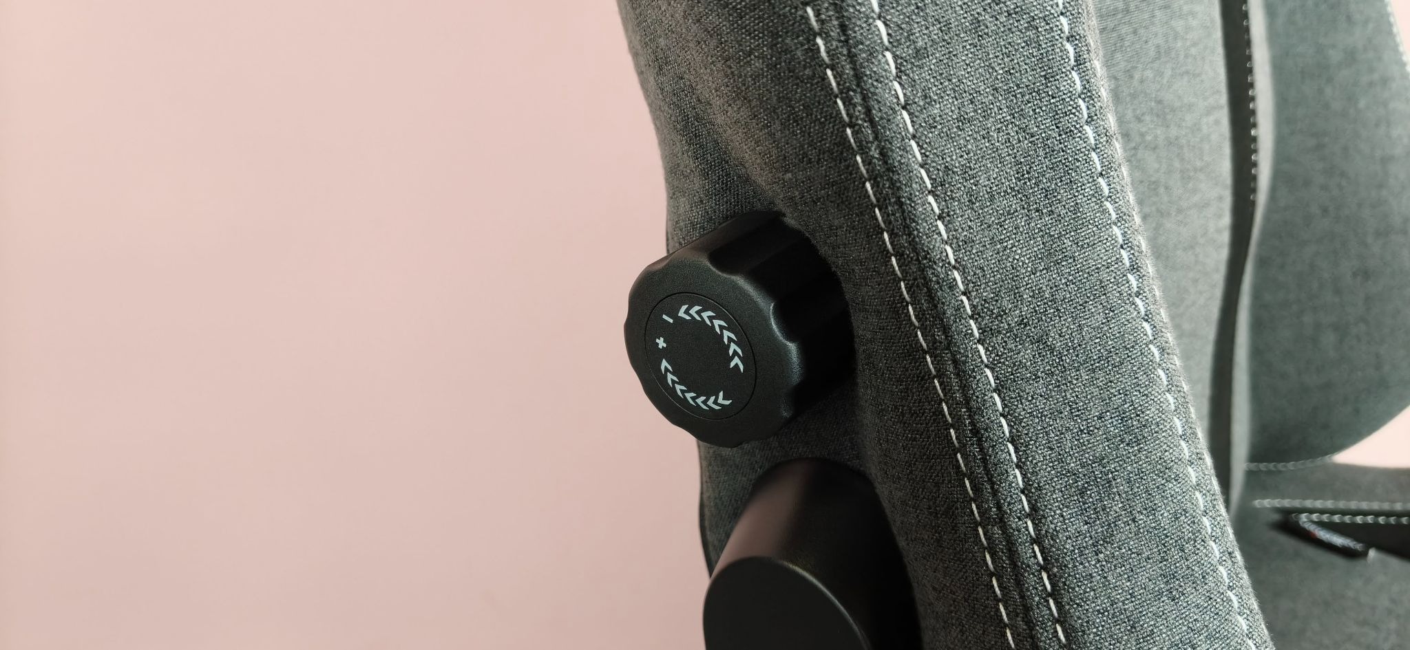 Close-up of lumbar dial on side of Boulies Master Rex (2026), against a pink background