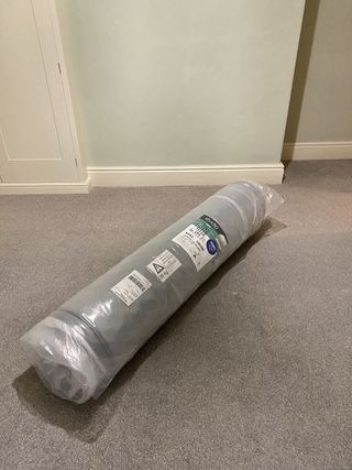 mattress rolled up on the floor