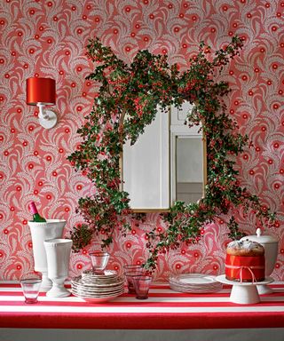 Pink dining space with mirror decorated with holly