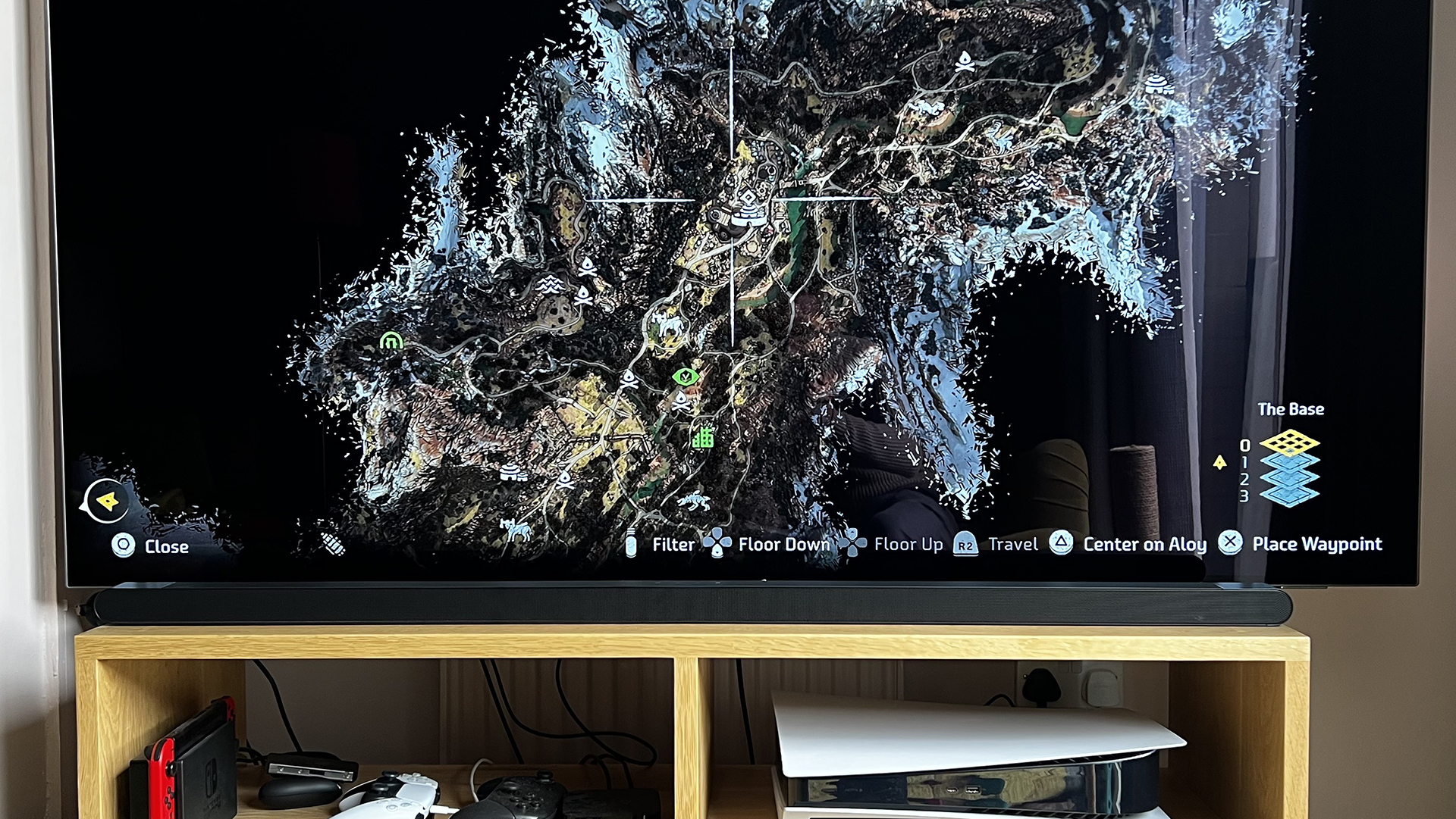Samsung S800B soundbar in front of TV playing video game. The text at the bottom is visible