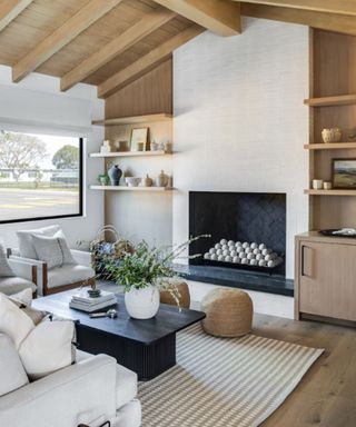 White fireplace, black coffee table, white armchair