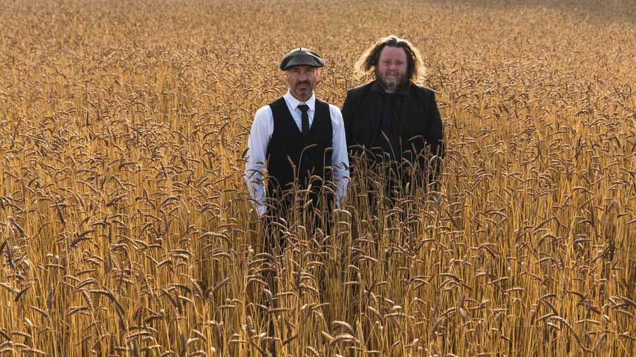 Inspector Cluzo standing in a field of wheat