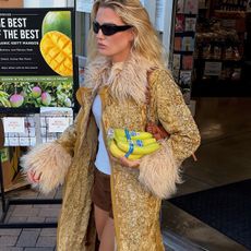 Woman in an ornate gold coat