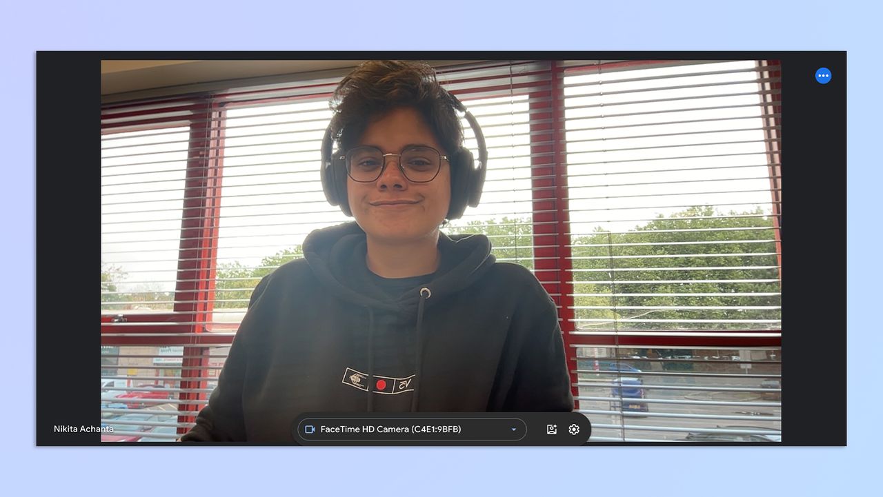 A still of a woman with short hair and headphones on, taken on a MacBook Air M2
