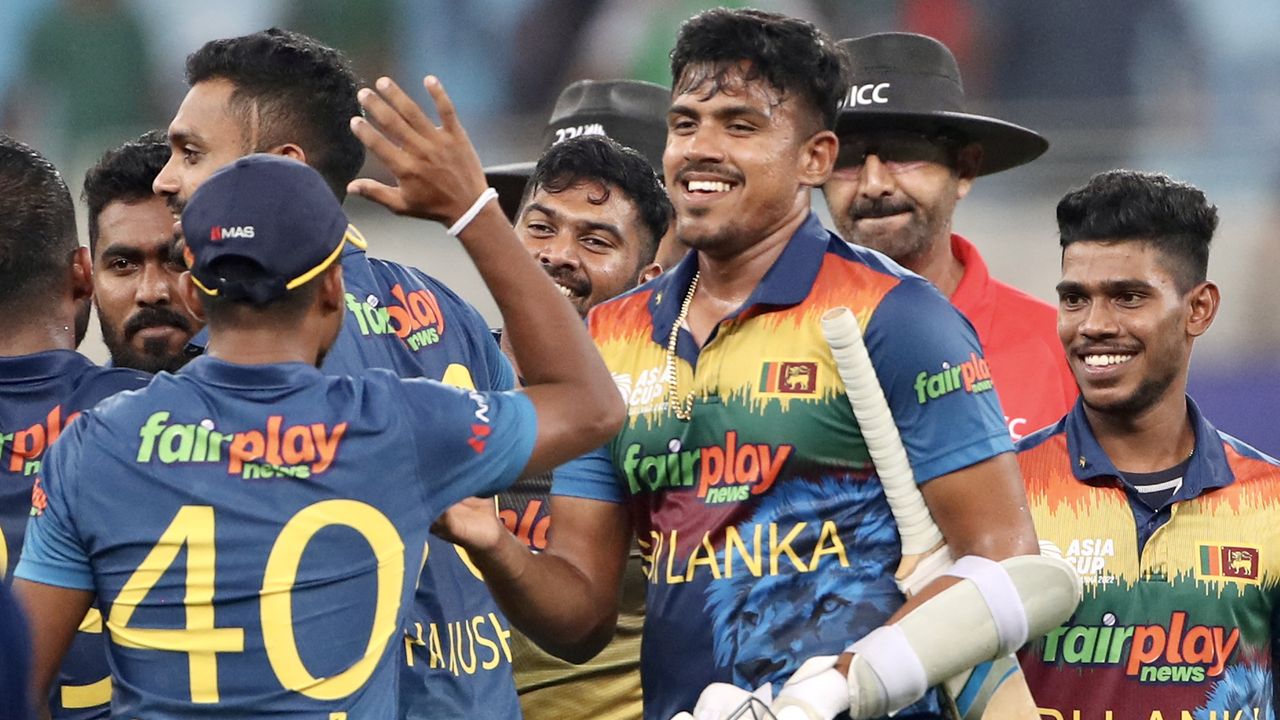 Sri Lanka&#039;s players celebrate their win as Bangladesh&#039;s captain Shakib Al Hasan walks past them during the Asia Cup Twenty20 international cricket match 