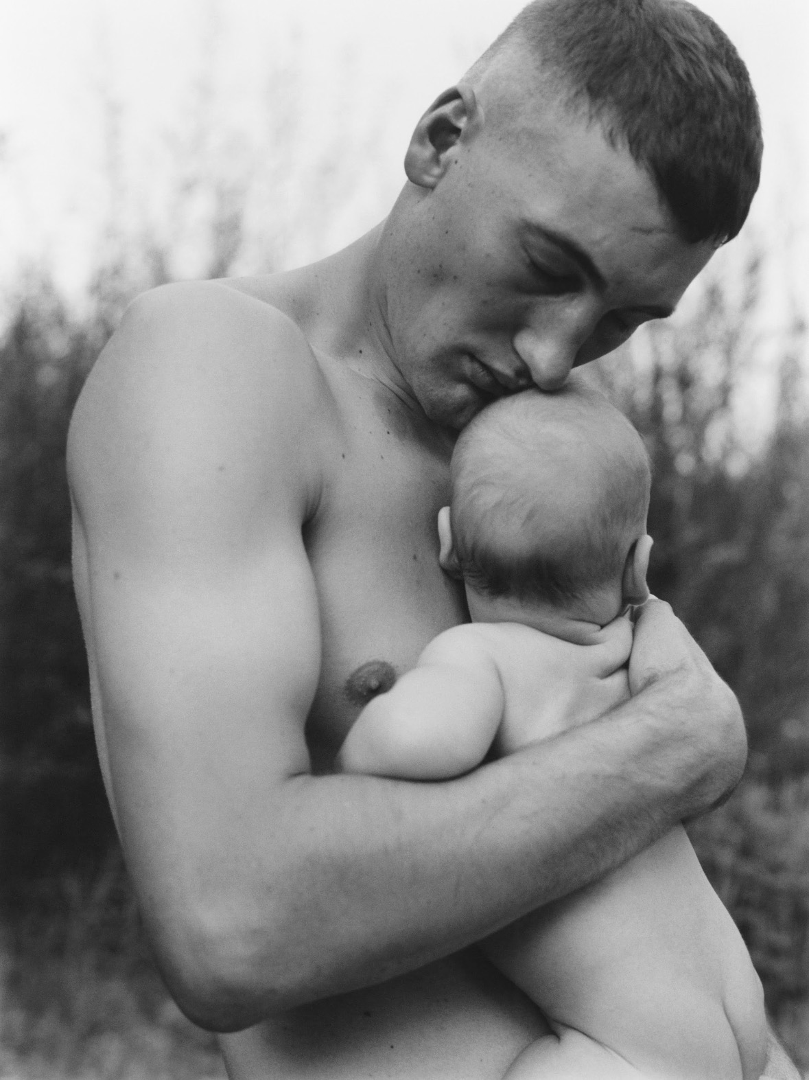 Man holding his young baby by Ania Brudna