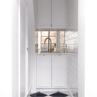 Bathroom with built-in top and bottom wall cabinets.