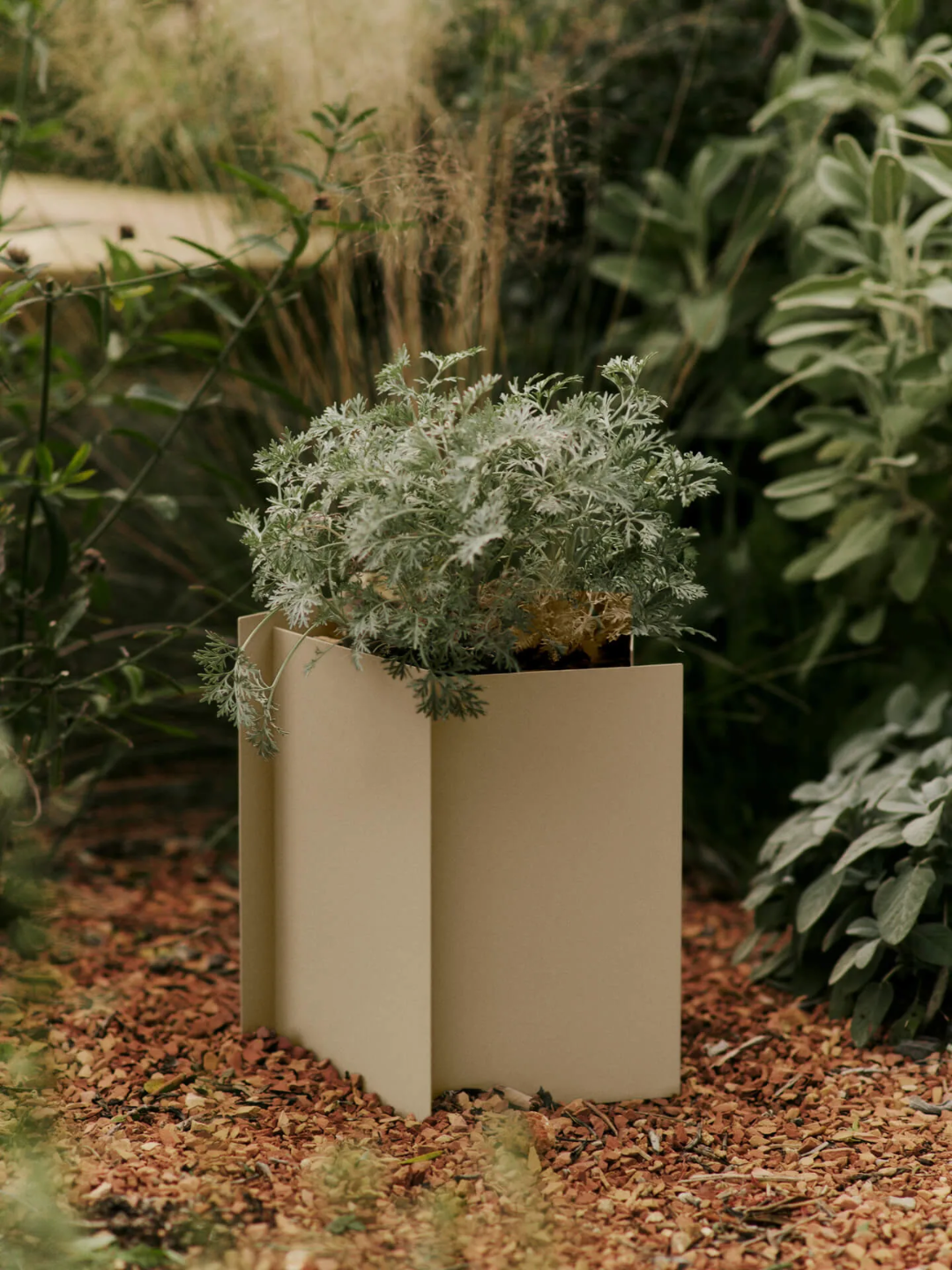 A cashmere-colored metal planter