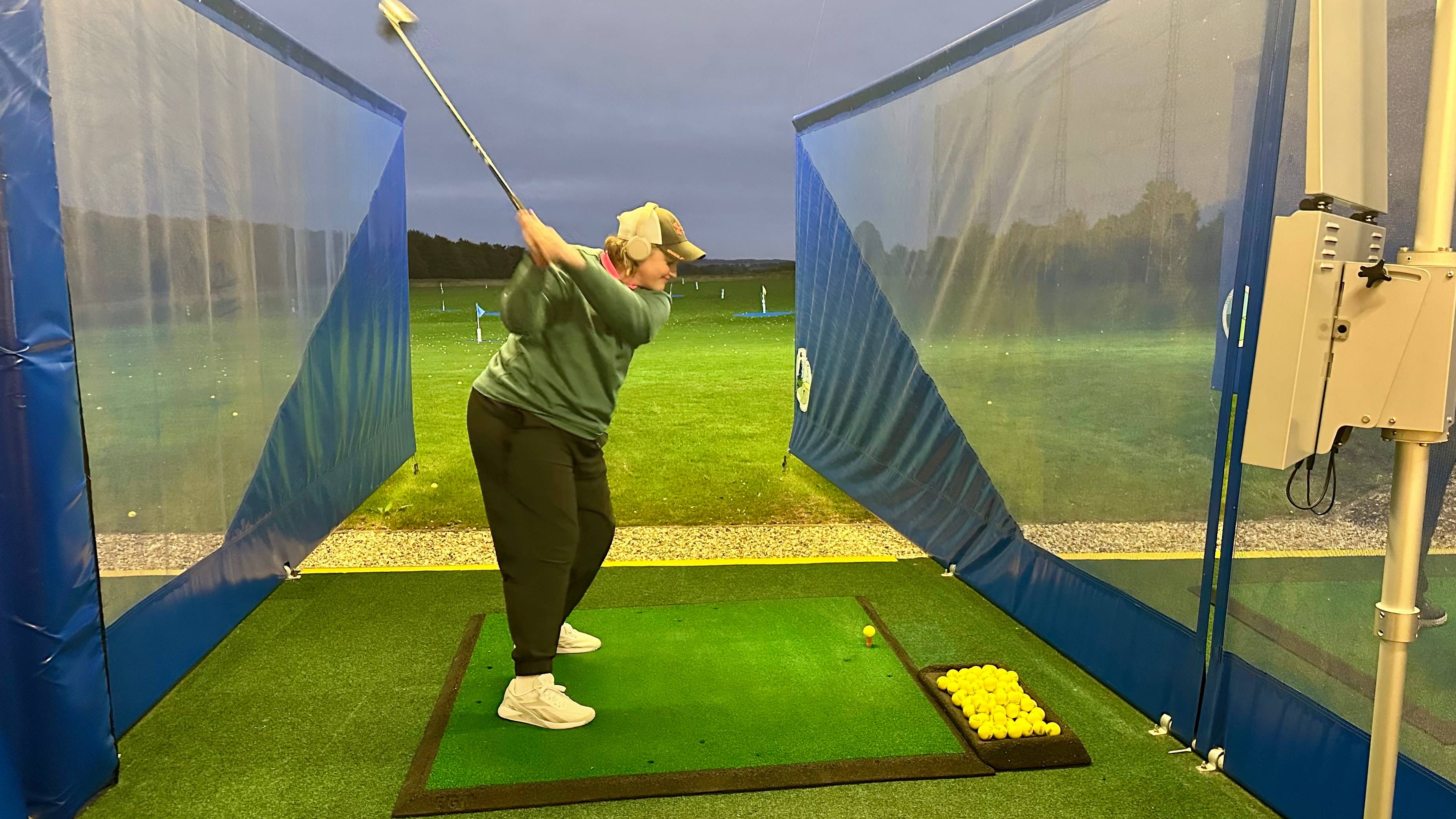 Emma Booth at the range wearing headphones