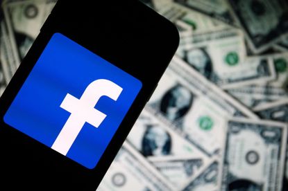 Facebook settlement: A Facebook logo on a stack of money.