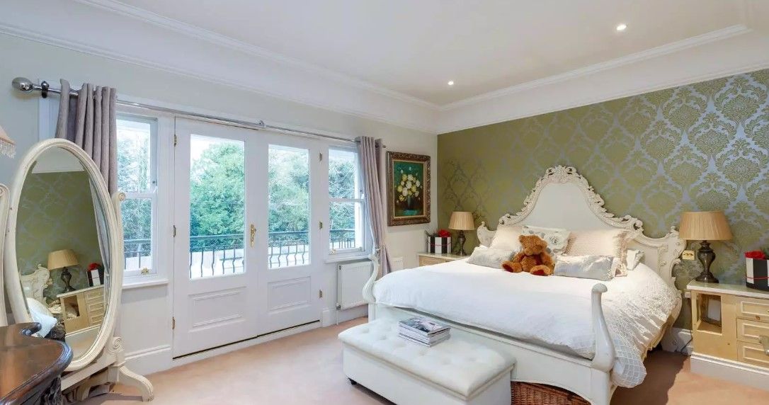 An upstairs bedroom has bifold doors which lead onto a balcony