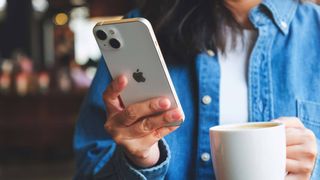 Woman using iPhone in a cafe