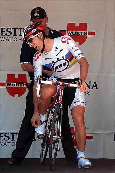 No, it's not Cancellara in pain but a last joke shared with the officials.