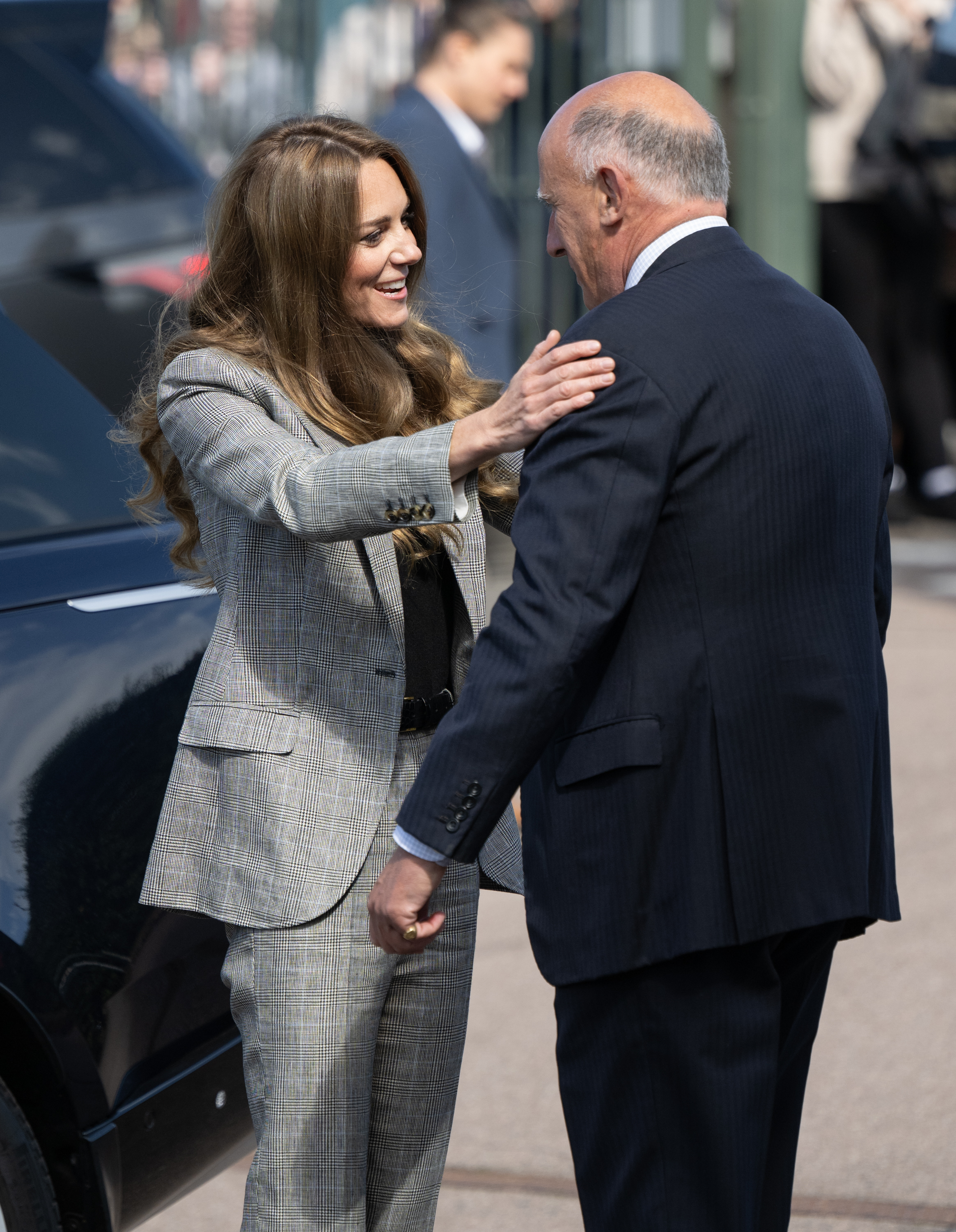 Princess Kate and Jamie Lowther-Pinkerton hugging in front of a car