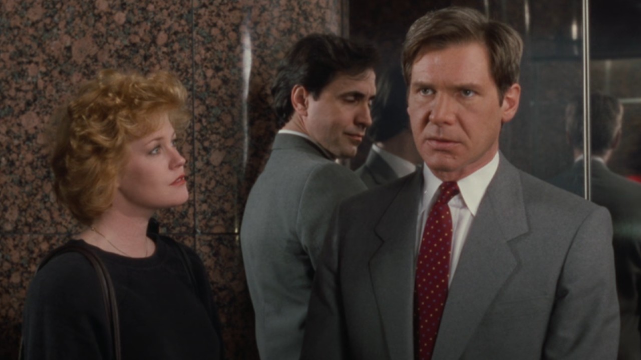 Melanie Griffith looking at Harrison Ford who is looking forward.