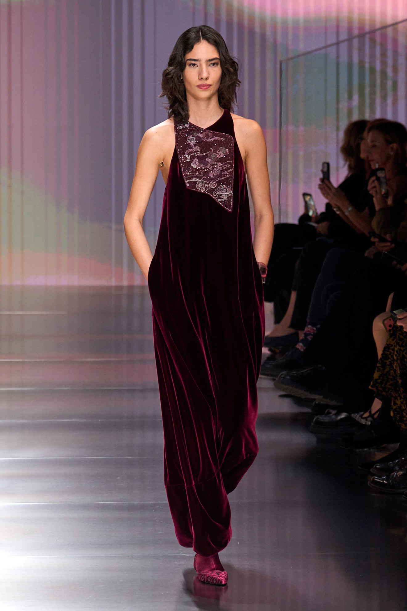 a woman walks the giorgio armani fall/winter 2026 show.