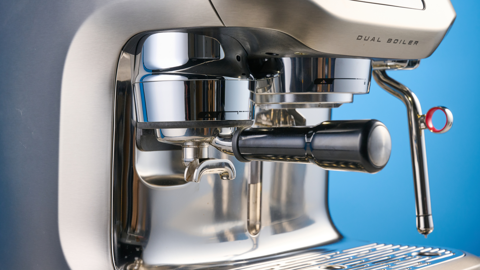 the breville oracle dual boiler / sage oracle dual boiler in stainless steel, showing its touchscreen, steam wand, built in grinder, and espresso shots