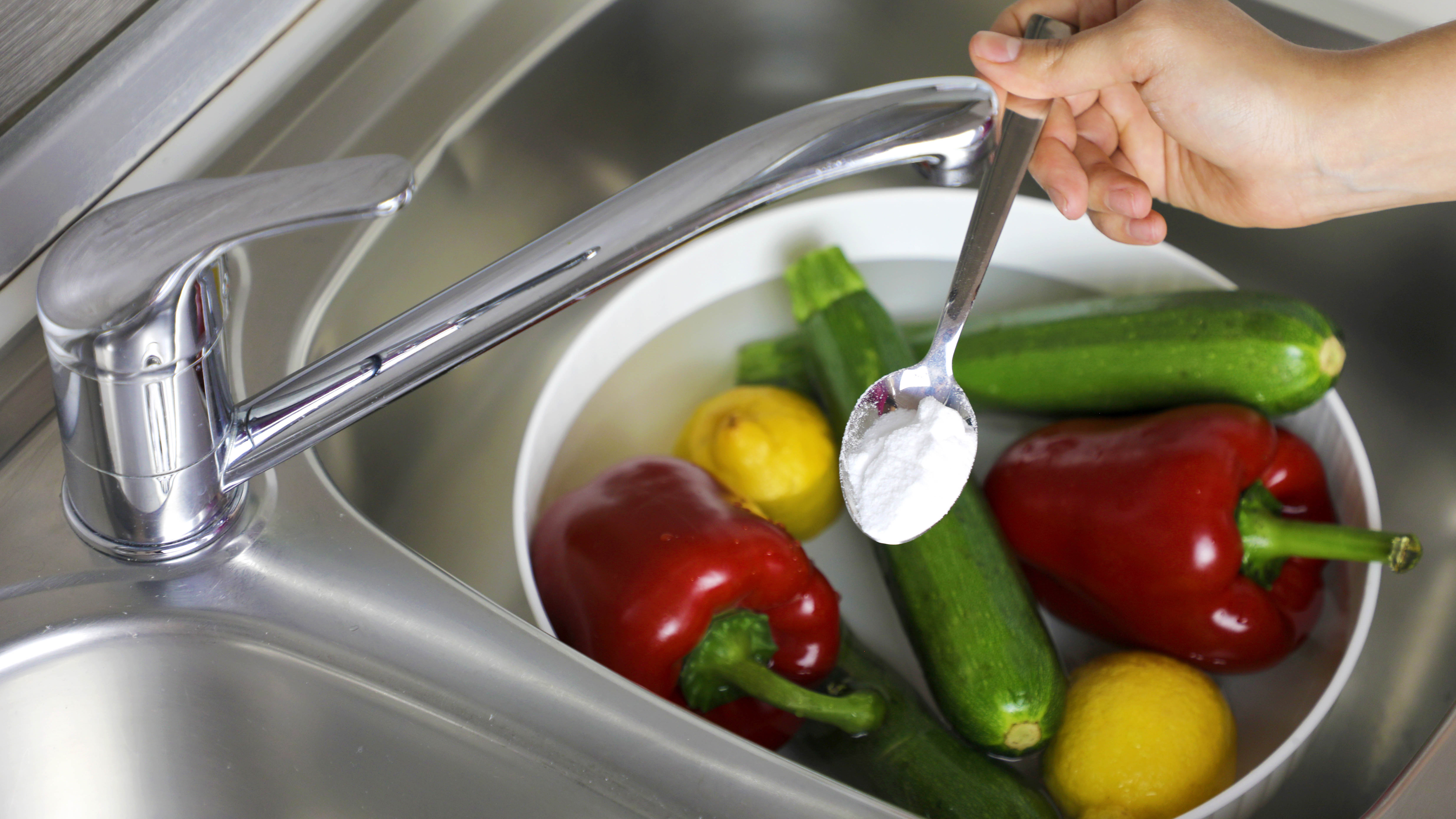 Baking soda sprinkled on bowl of fruits and vegetables