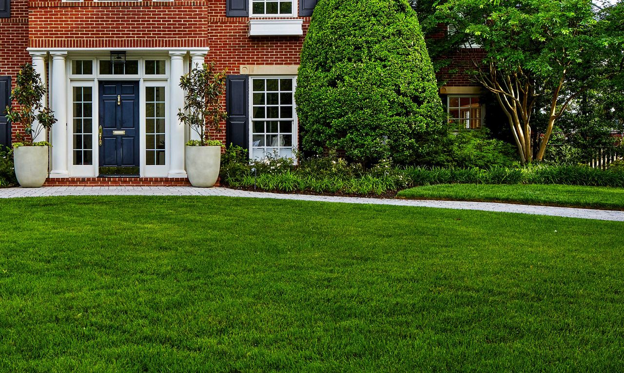 a well kept lawn at the front of a house