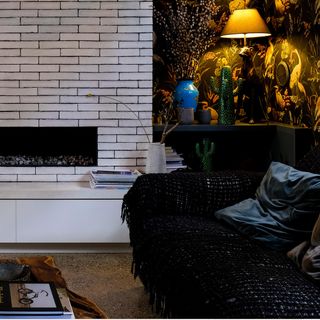 room with white brick wall and fire place