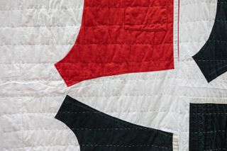 detail of quilt with black and red shapes