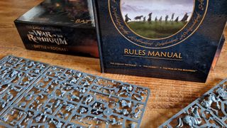 Battle of Edoras sprues, rules manual, and box on a wooden table