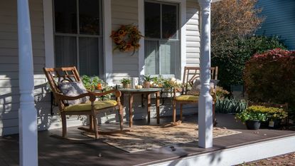 Picture of two wooden rocking chairs and a table on a front porch