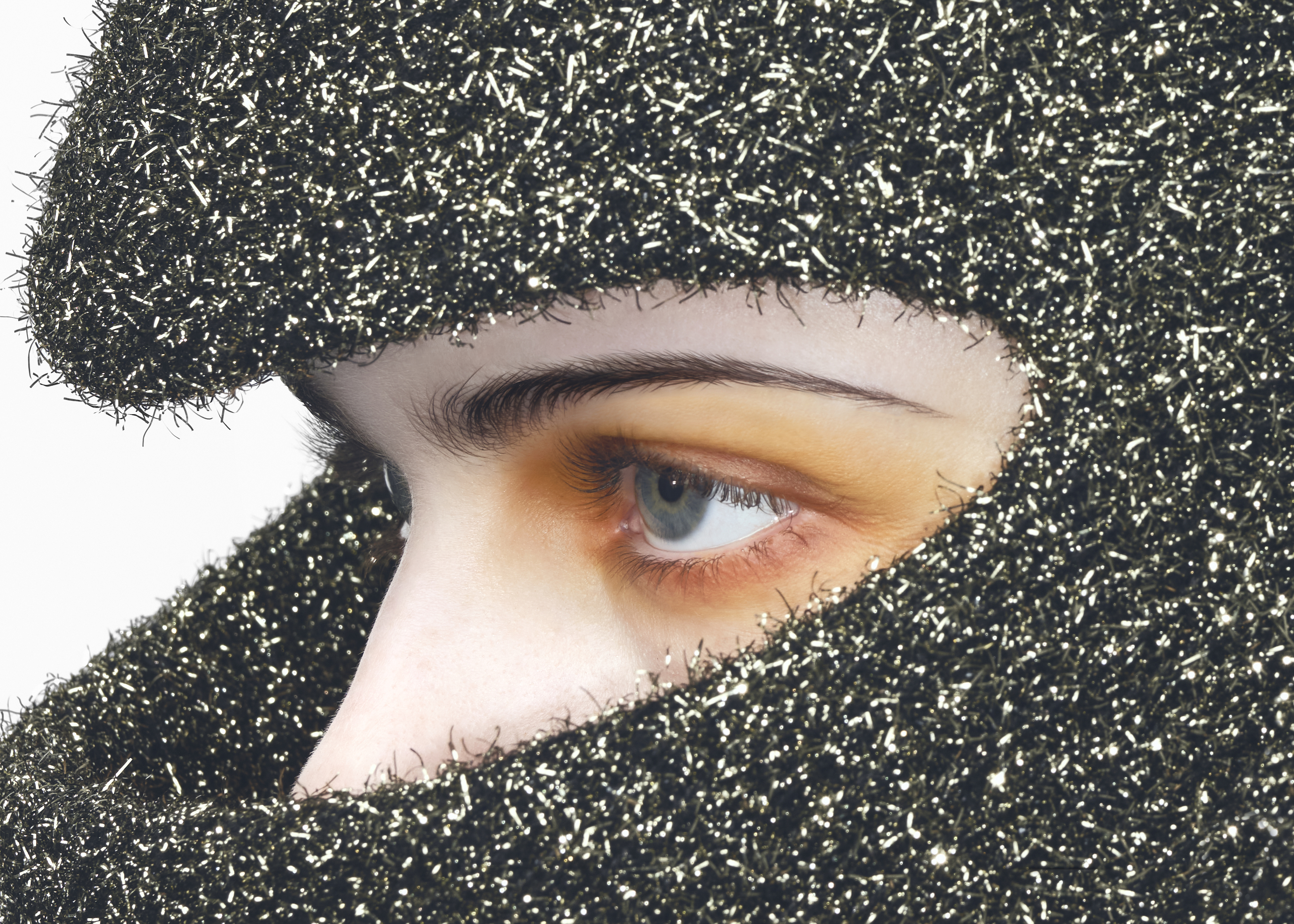 Women wearing yellow eyeshadow and silver and black hood