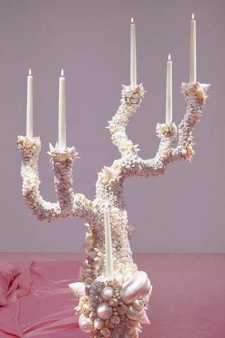 A coral shaped candelabra covered with sea shells by Sylvie Macmillan for Acne Studios S/S 2023 show set.