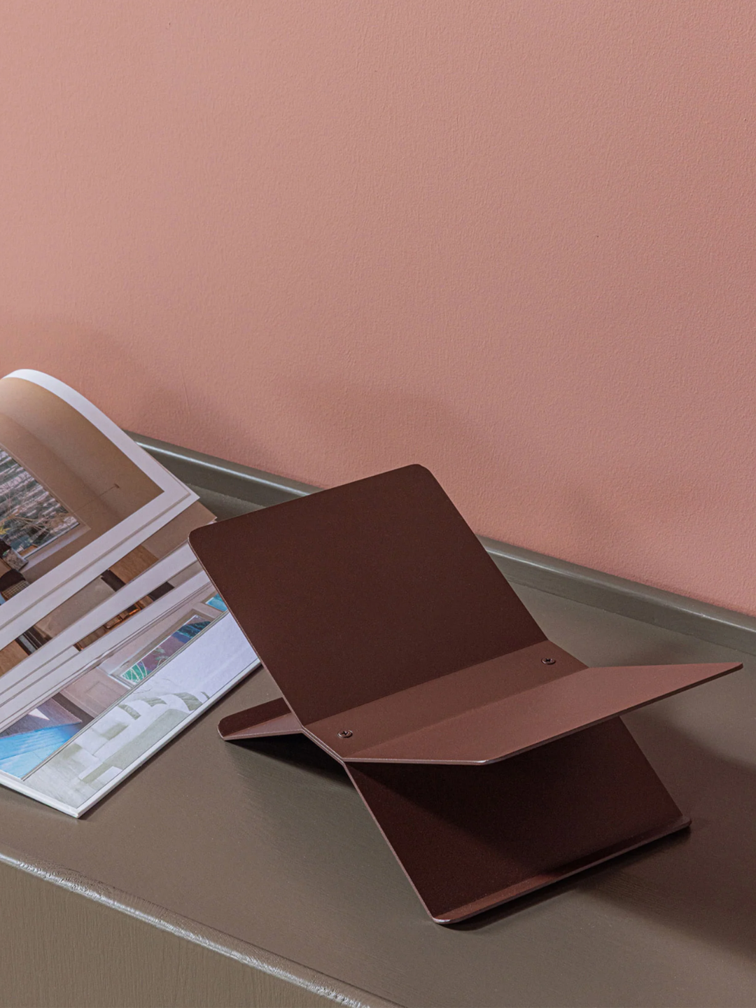 A brown metal book stand from WOOOD