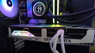 White RTX 4080 Super installed within PC case next to AIO cooler