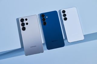 Three Samsung Galaxy S25 phones on a blue background