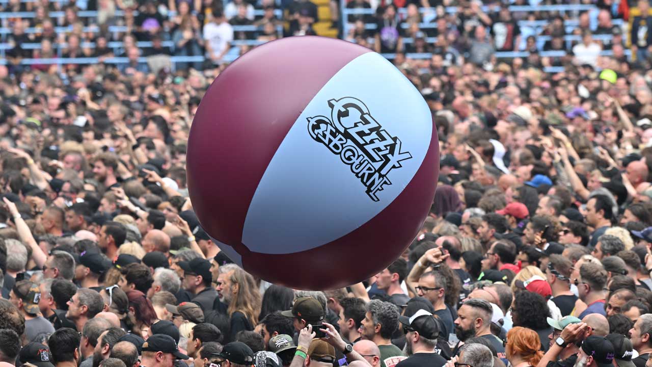 An inflatable Ozzy Osbourne beach ball in Aston Villa colours bouncing over the crowd at Villa Park