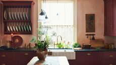 Kitchen with burgundy cabinets and open dish storage in an eye-level open cabinet