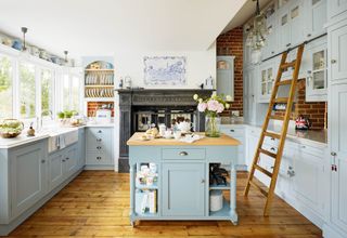 Kitchen with blue cabinets and island and wood floor