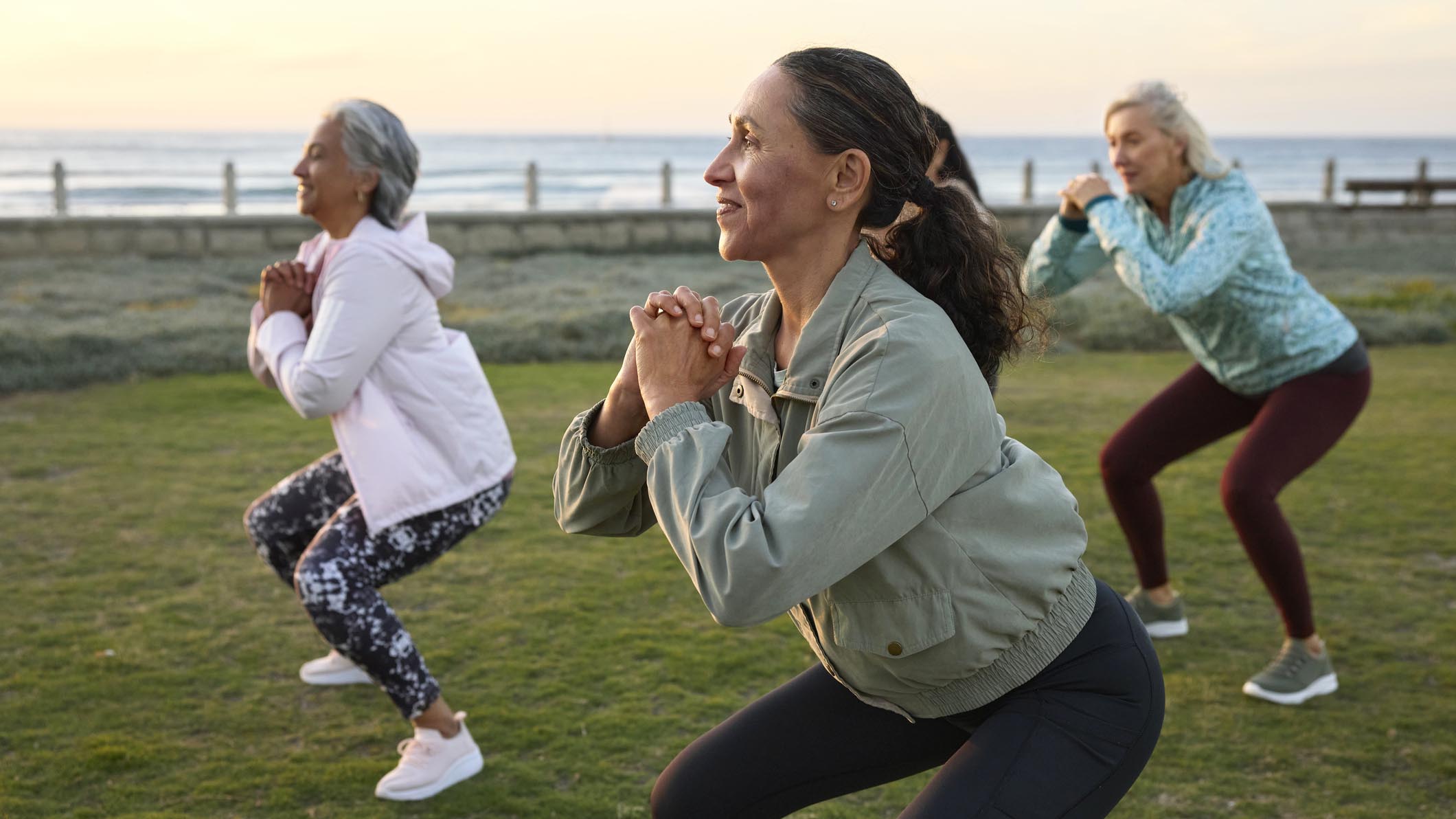 a group of middle-aged women doing squats