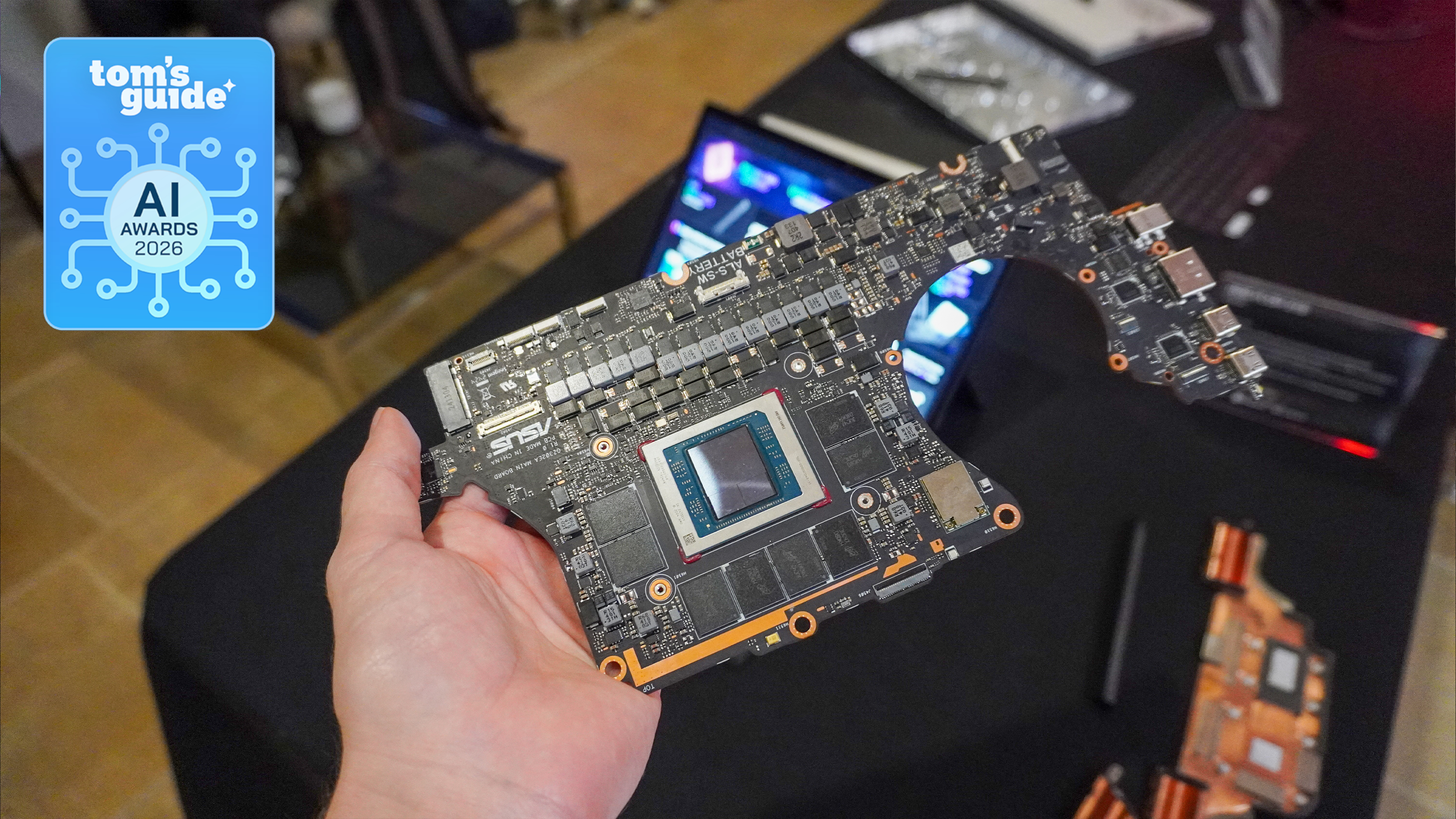 A motherboard with a AMD Ryzen AI Max chip on it in hand with a Tom's Guide AI Awards 2026 badge