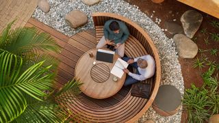 An overhead view of two business people talking