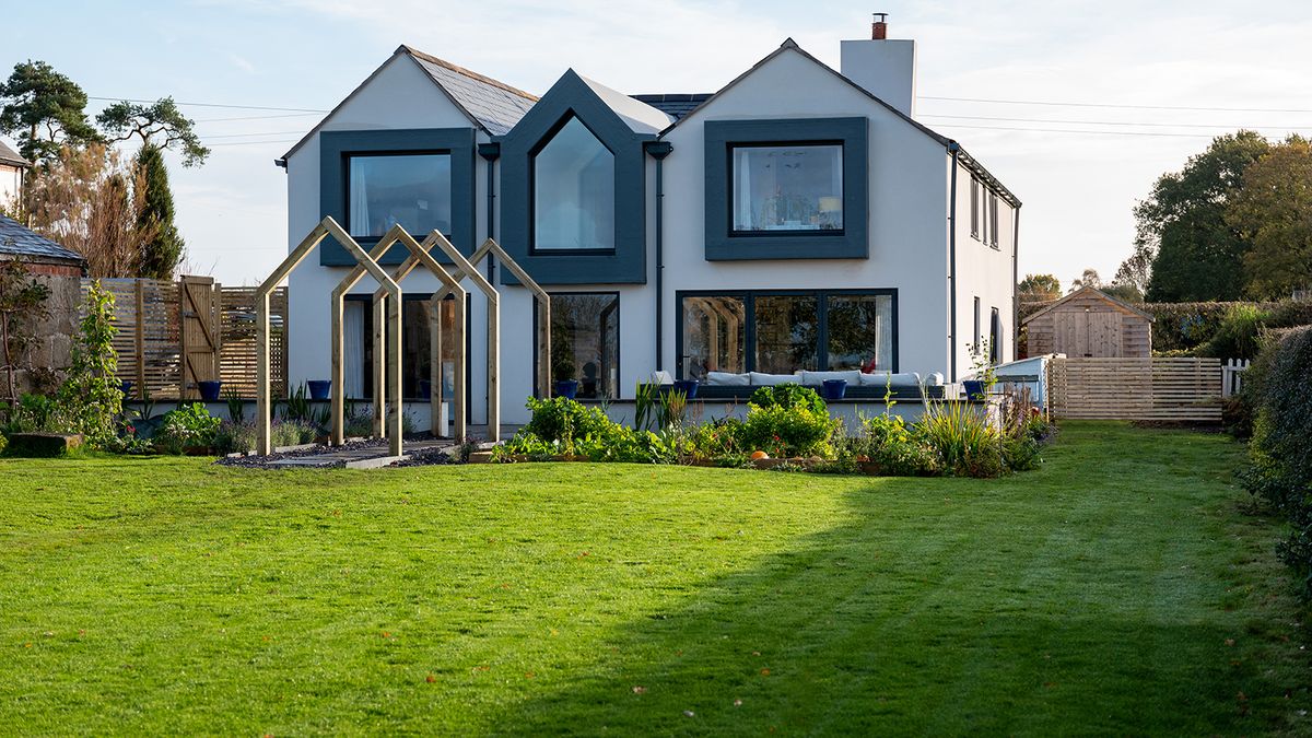 An expansive lush green lawn growing in front of a newly renovated home